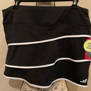Black knit with white trim skort.  With Tennis ball pocket.